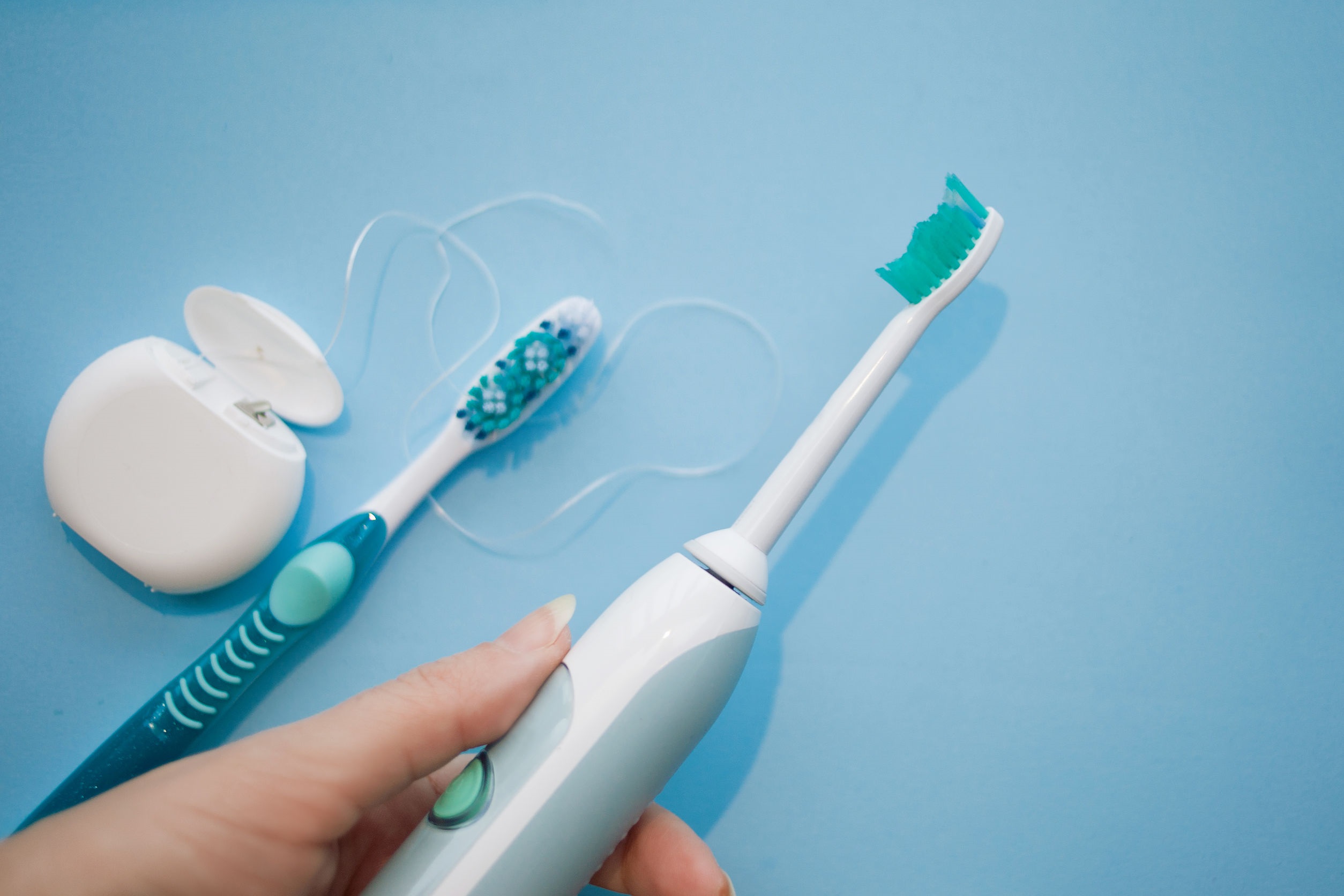 Choose a modern toothbrush. The hand holding the sonic toothbrush