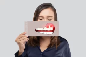 A female patient of Andrew Baderski Dental holding a gum illustration