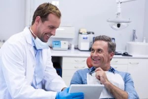 The dentist at Andrew Baderski Dental is explaining the treatment to the patient