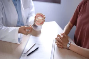 The dentist at Andrew Baderski Dental is explaining the dental treament plan to the patient